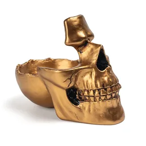 Detailed macro view of a golden resin skull sculpture used as a creative glasses holder