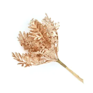 Close-up view of elegant golden artificial fern leaves for DIY floral bouquet decor