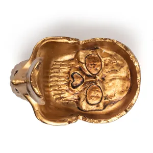Detailed top-down view of a golden resin skull sculpture for eyeglasses and keys holder