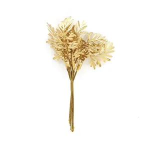 Close-up of golden artificial fern leaves for DIY floral arrangements and crafts