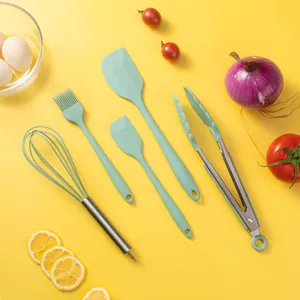 Mint green 5-piece silicone kitchen utensil set with baking ingredients on yellow base