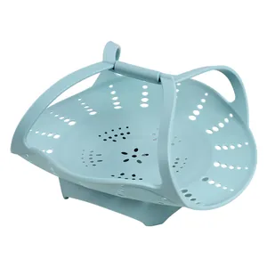 Heat resistant light blue silicone steamer basket with handles for healthy kitchen cooking