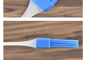 Close-up macro detail showing blue heat-resistant silicone bristles on a kitchen oil brush