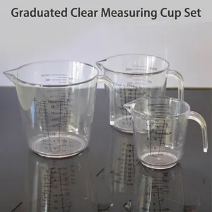 Set of three transparent plastic measuring cups with scales and handles for baking.