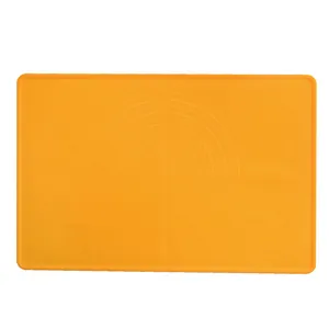 Orange food-grade silicone baking mat with circular measurements and non-stick surface.