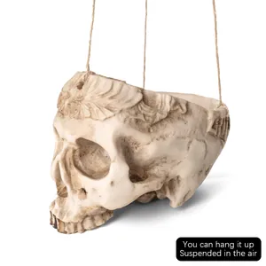 Detailed antique-style carved resin skull model with hanging strings for Halloween decor