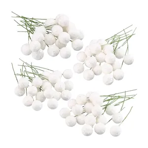 Detailed view of four clusters of white glitter artificial Christmas berry stems