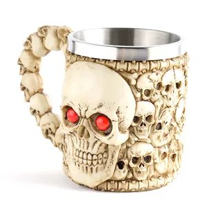 Macro detail view of a gothic resin skull mug with red eyes and stainless steel liner