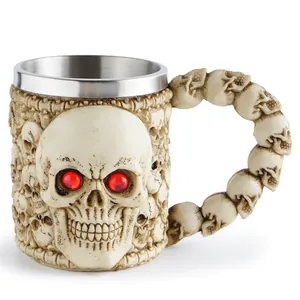 Detailed close-up of a gothic skull mug with red eyes and intricate resin carving design