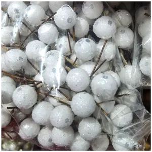 Detailed macro view of white glitter artificial holly berries for DIY Christmas crafts