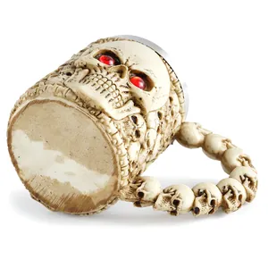 Close-up detailed view of resin skull mug with intricate bone texture and red eyes