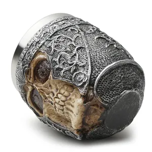 Detailed side view of a Gothic resin skull cup featuring ornate metallic silver relief