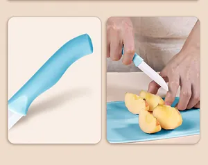 Detail showing the ergonomic blue handle and ceramic knife cutting an apple on a board.
