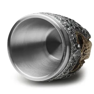 Close-up showing the brushed stainless steel liner and gothic skull resin carving details