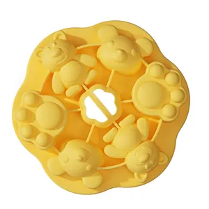Yellow silicone baby food mold with bear and cat paw shapes for baking