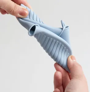 Detailed view of flexible light blue food grade silicone oven mitt showing durability
