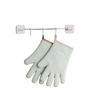 Heat resistant mint green silicone oven mitts with non-slip texture on white background