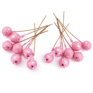 Close-up view of pink glitter artificial berries for Christmas floral decoration