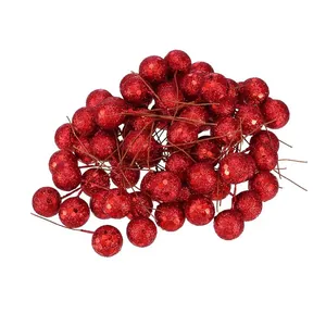 Close-up macro view of glittery artificial red berries for Christmas DIY festive decorations