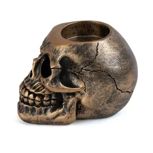 Antique bronze resin skull candle holder with realistic aged texture macro detail view
