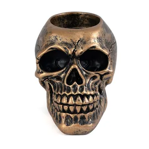 Detailed macro view of a bronze resin skull candle holder featuring realistic bone texture