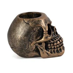 Detailed side view of antique bronze resin skull candle holder for spooky decor