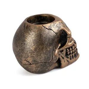 Close-up view of antique bronze resin skull candle holder for gothic home atmosphere decor
