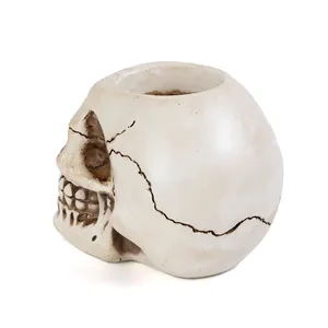 Side profile detail of a realistic resin skull candle holder with aged crack textures