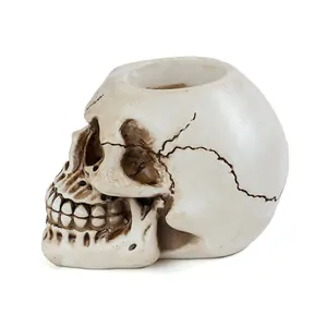 Side profile of a realistic resin skull candle holder for spooky Halloween home decor