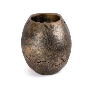 Detailed view of aged metallic finish and cracked texture on resin skull candle holder