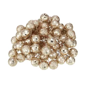 Detailed view of golden glitter artificial berries with brown stems for DIY crafts.