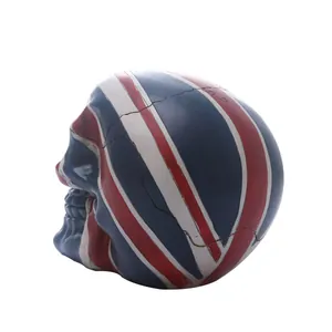 Side view of realistic skull figurine painted with British Union Jack flag pattern