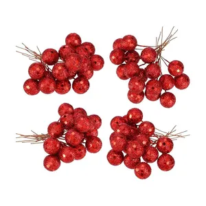 Close-up detail of artificial red glitter berries with stems for Christmas DIY decor.