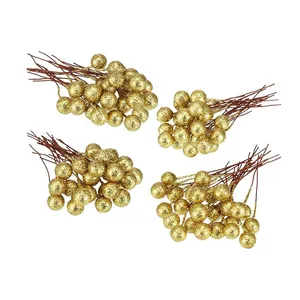 Detail view of four clusters of artificial golden glitter berries for Christmas DIY decor