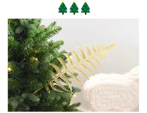 Detailed view of a glittering golden artificial fern leaf for Christmas tree decor