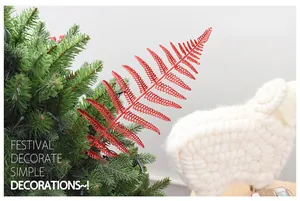 Detailed view of festive red glittery fern leaf decoration ornament on Christmas tree