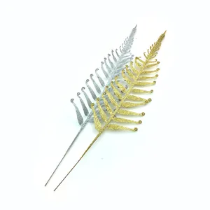 Detailed view of gold and silver glitter fern leaves for Christmas tree decoration