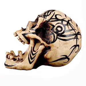 Close-up detail of black tribal pattern engravings on a decorative cream resin skull