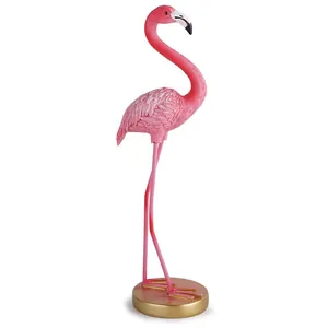 Élégante figurine de flamant rose avec plumes détaillées sur un socle doré rond