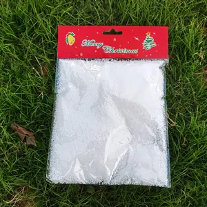 Close-up detail of artificial white snow powder in festive Merry Christmas packaging bag