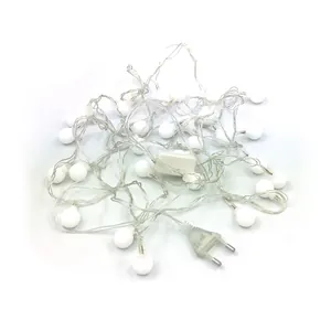 Detailed view of frosted white globe LED string lights with European power plug