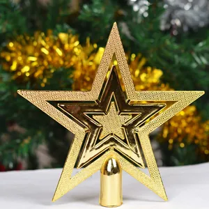 Detailed close-up of a glittering gold three-layer Christmas tree topper star decoration
