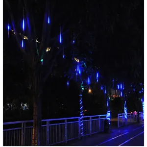 Blue meteor shower rain lights hanging on trees for outdoor Christmas decorations