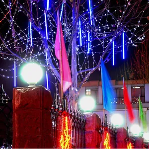 Blue LED meteor shower lights hanging on outdoor trees for Christmas decor
