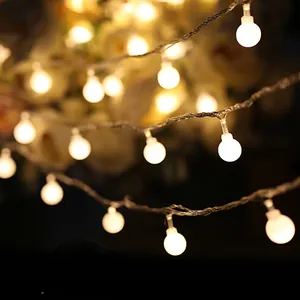 Warm glowing frosted ball LED string lights perfect for festive Christmas holiday decor.