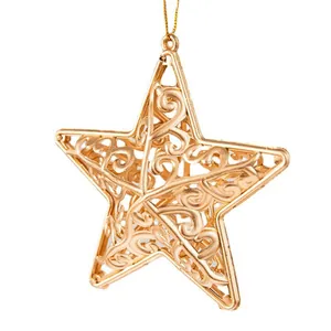 Close-up of a golden hollow five-pointed star Christmas ornament with scroll patterns