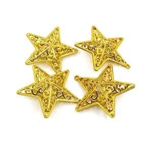 Four golden hollowed-out star ornaments for Christmas tree decoration on white background.