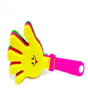 Close-up detail of large multi-colored plastic hand clapper noise maker for parties