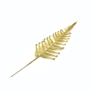 Detailed view of a golden glitter fern leaf Christmas tree decoration accessory.