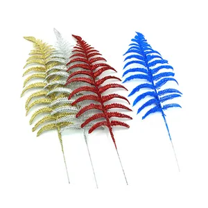 Glittery artificial fern leaves in gold, silver, red, and blue for Christmas decor